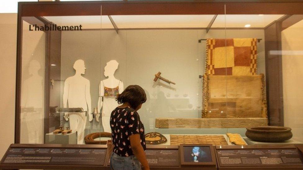 A woman looks at exhibit in new museum