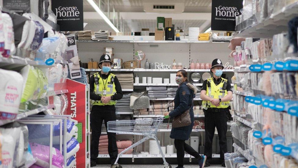 Police officers at Asda Watford Supercentre in Hertfordshire which is being used as a community pharmacy vaccination centre