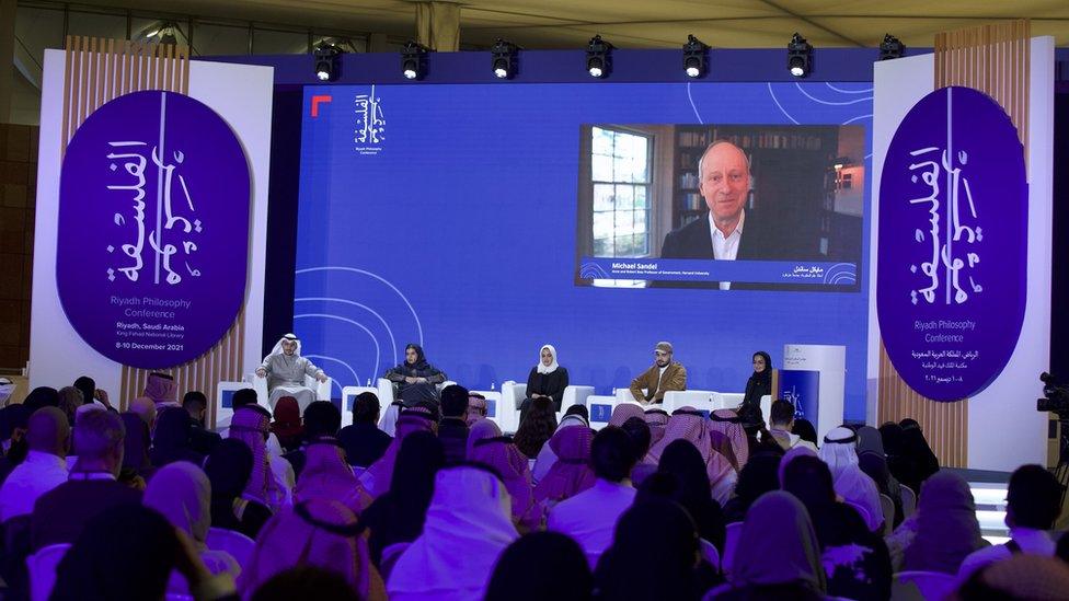 Michael Sandel on screen at philosophy conference