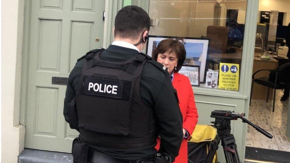 Diane Dodds speaking to a PSNI officer