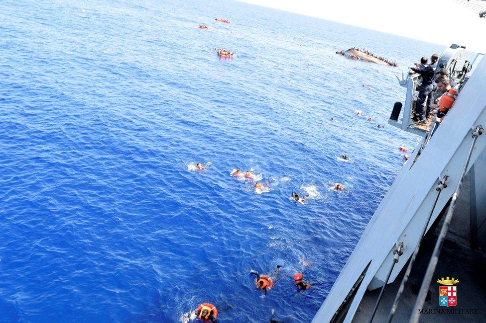 Migrants escape from a capsizing boat in the Mediterranean, 25 May