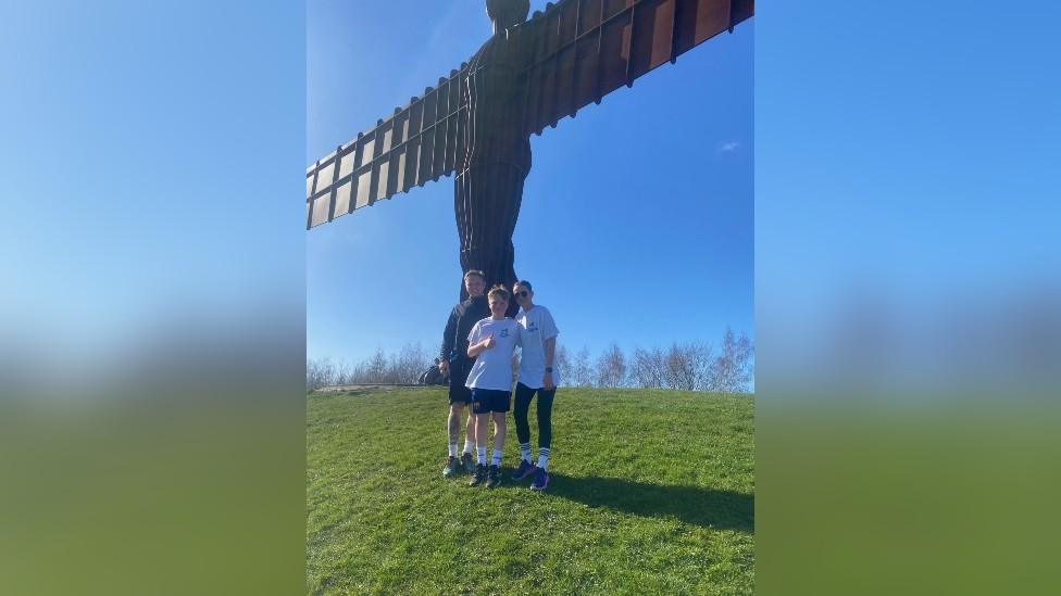 Charlie with his parents by the Angel of the North