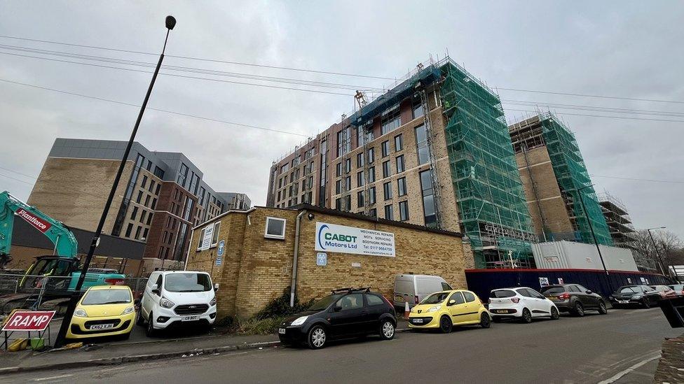 A wide shot of tower blocks under construction surrounded by scaffolding