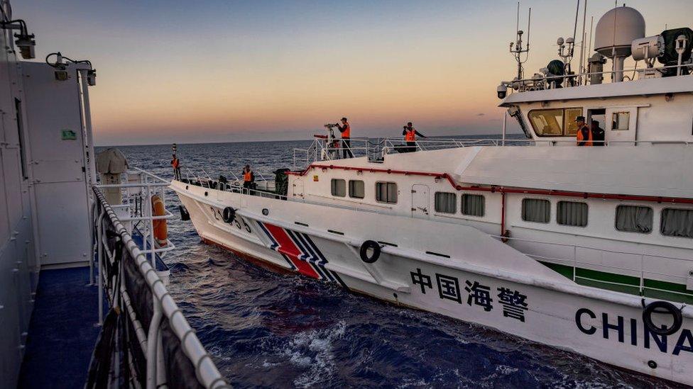 A Chinese Coast Guard ship sails near Philippine Coast Guard ship BRP Sindangan during a resupply mission to troops stationed at Second Thomas Shoal, on March 5, 2024 in the South China Sea.