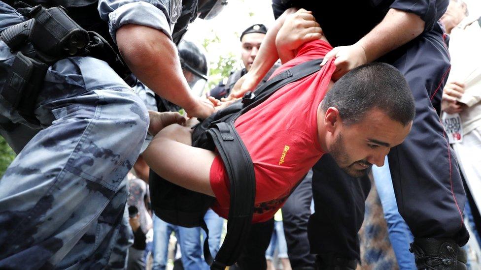 Russian riot police detain a protester at a rally in support of journalist Ivan Golunov in Moscow, Russia, 12 June 2019