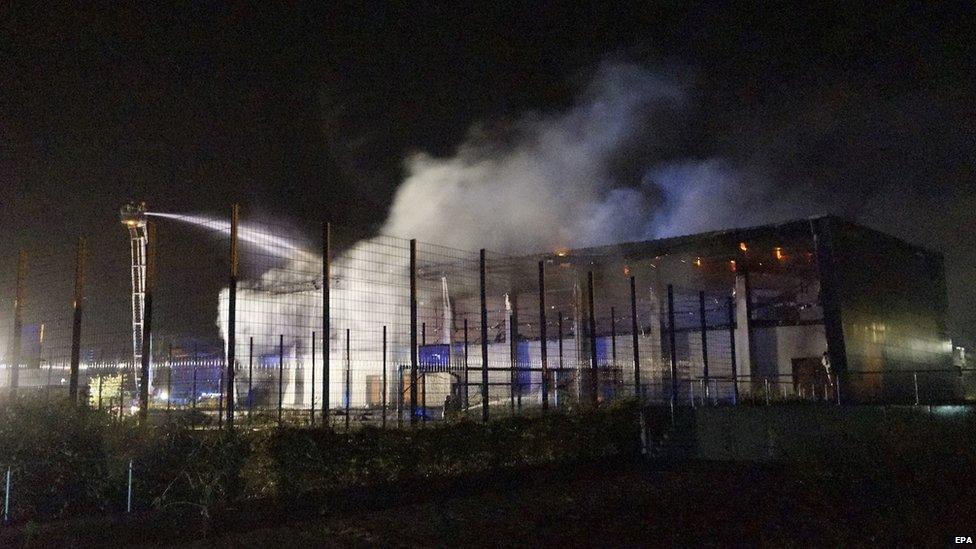 Firefighters try to extinguish a fire in the gym in Nauen, Germany, 25 August 2015