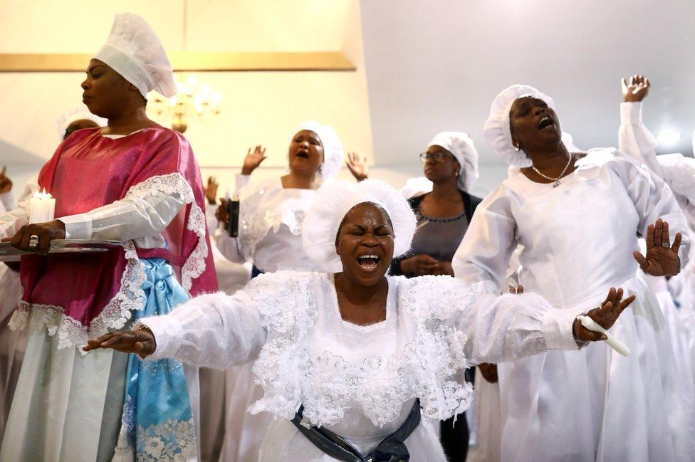 Worshippers sing as they offer thanksgivings during Sunday service