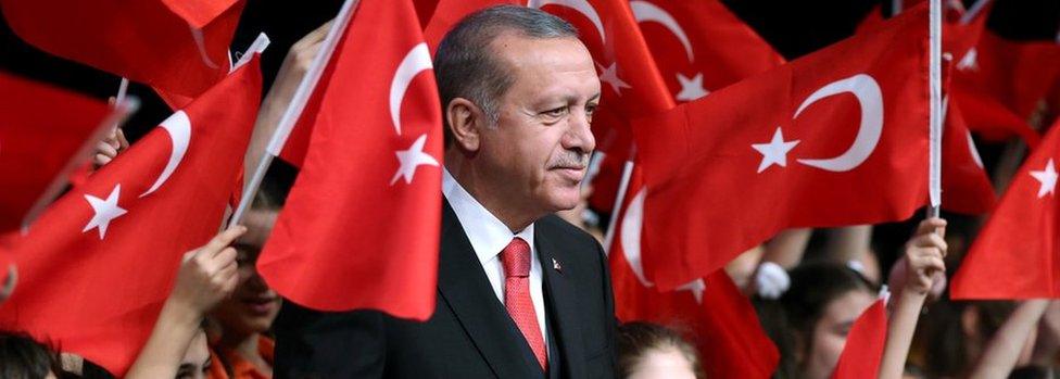 Turkish President Tayyip Erdogan poses with children during a ceremony to mark the National Sovereignty and Children's Day on 23 April 2017