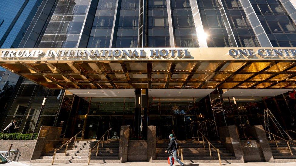 A person walks outside the Trump International Hotel and Tower in New York City