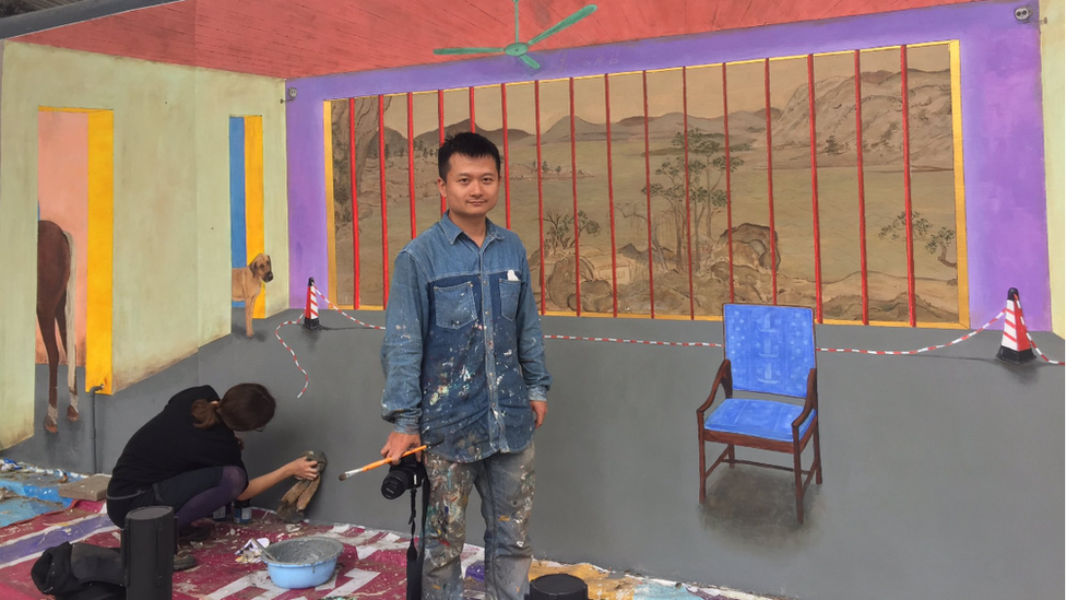 Hu Jiamin and Marine Brossard beside their mural