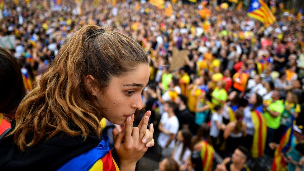 Protesters wave flags in the street as a general strike is called following a week of protests over the jail sentences given to separatist politicians by Spain’s Supreme Court, 18 October 2019