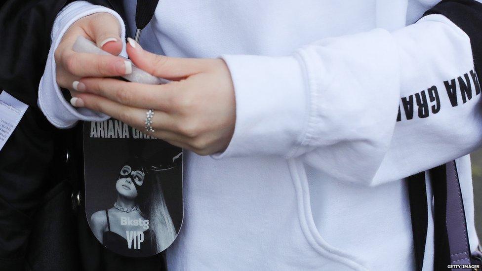 Teenager wearing Ariana Grande merchandise