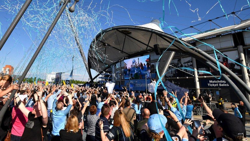 ticker tape explodes into air outside Etihad