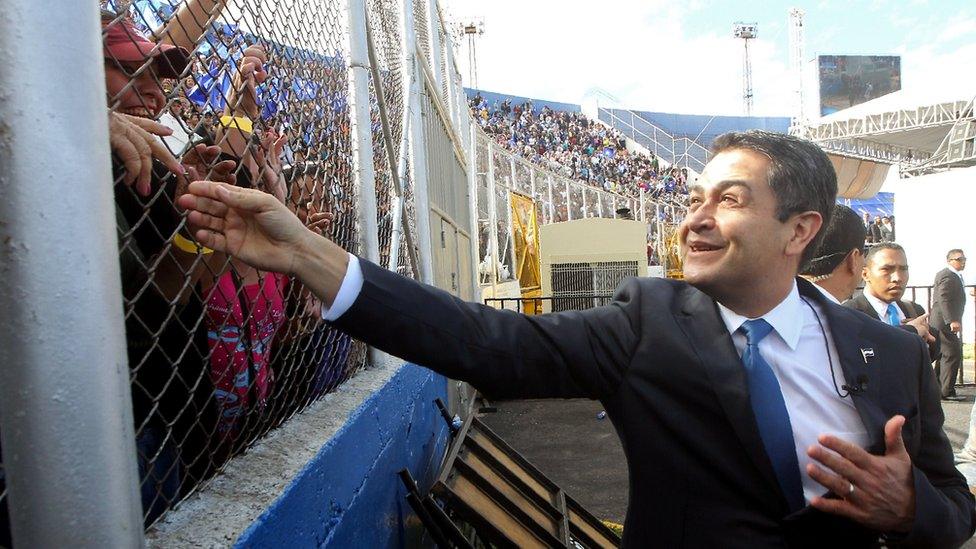 Reelected President Juan Orlando Hernandez waves to the crowd at his arrival to the inauguration ceremony at the Tiburcio Carias Andino national stadium, in Tegucigalpa, on January 27,