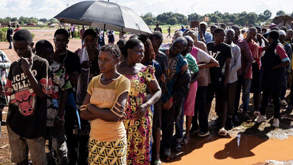 Voters queue as they wait to cast their ballots at a polling station at Bwakya school in Lubumbashi on December 21, 2023