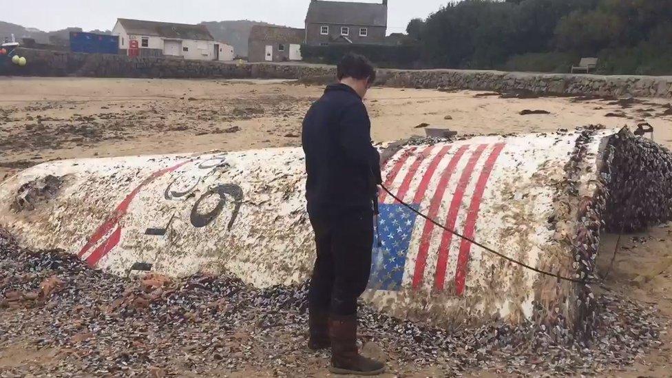 Man cleans barnacles off the rocket