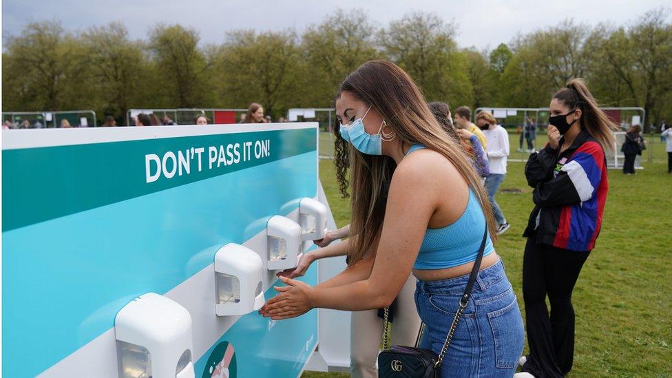 Music fans using hand sanitisers at the pilot concert in Liverpool's Sefton Park on 2 May, 2021