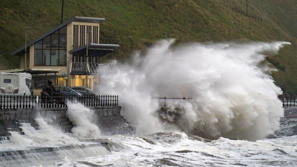 Large waves crash over the promenade at Scarborough