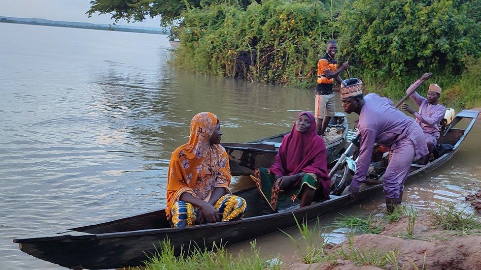 People in a wooden boat