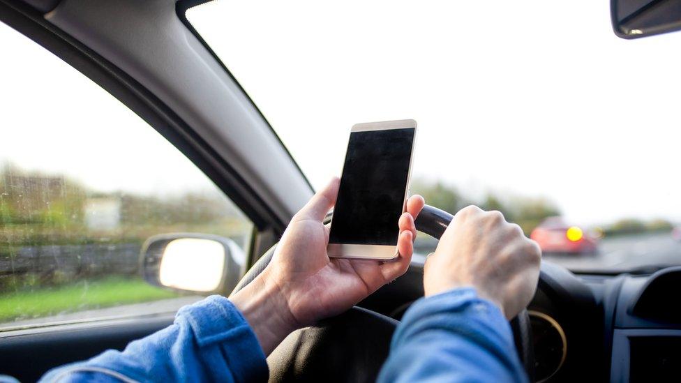 The government says it's looking at changing the law when it comes to driving and using your phone