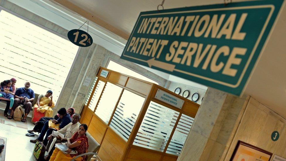 Sign reading "international patient service" in a hospital in Chennai, India