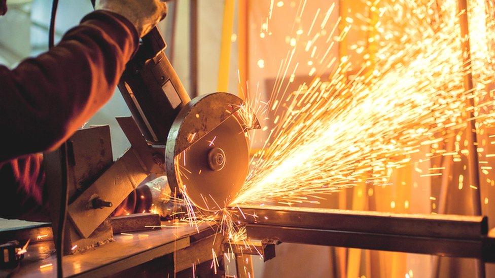 Worker using electric grinder