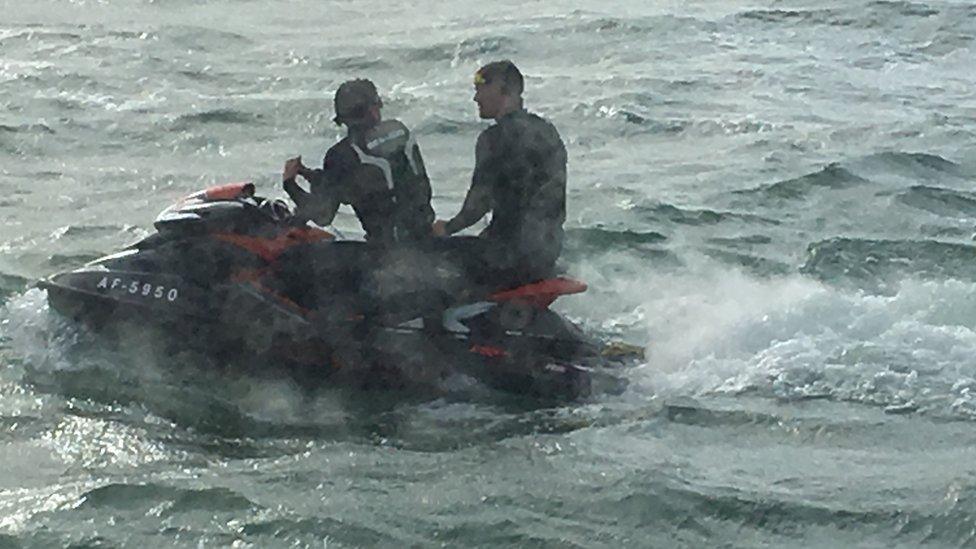 Two men on a personal watercraft