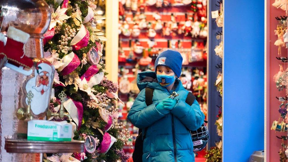 boy-wearing-mask-in-Christmas-shop