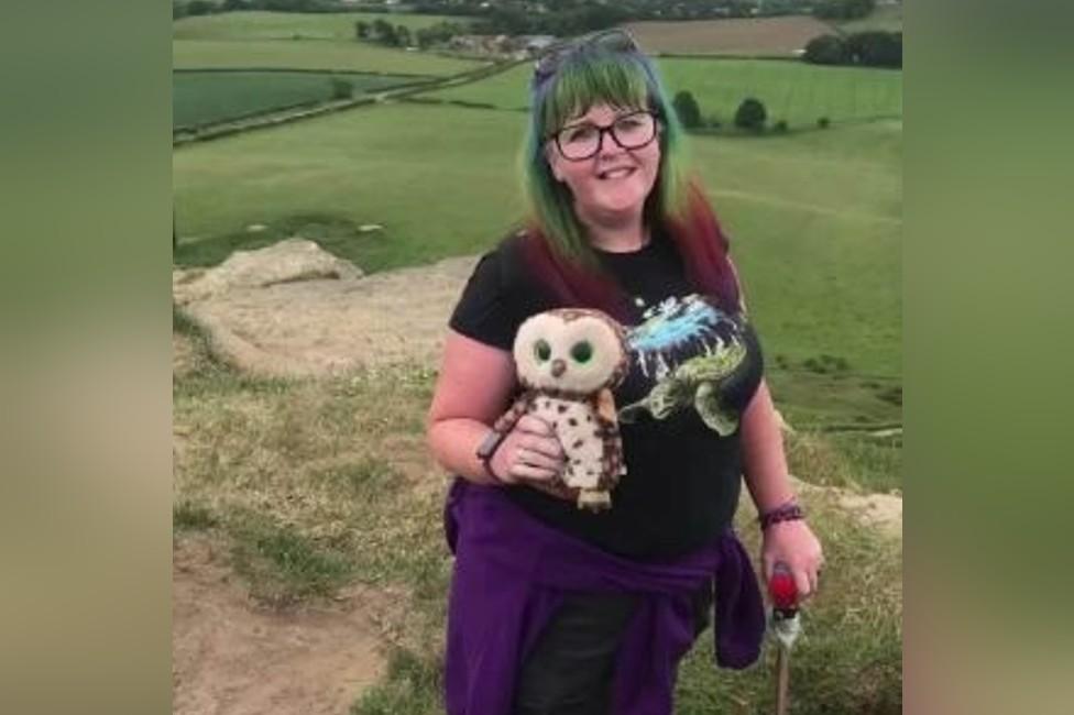 Wendy holding a toy owl as she walks outside