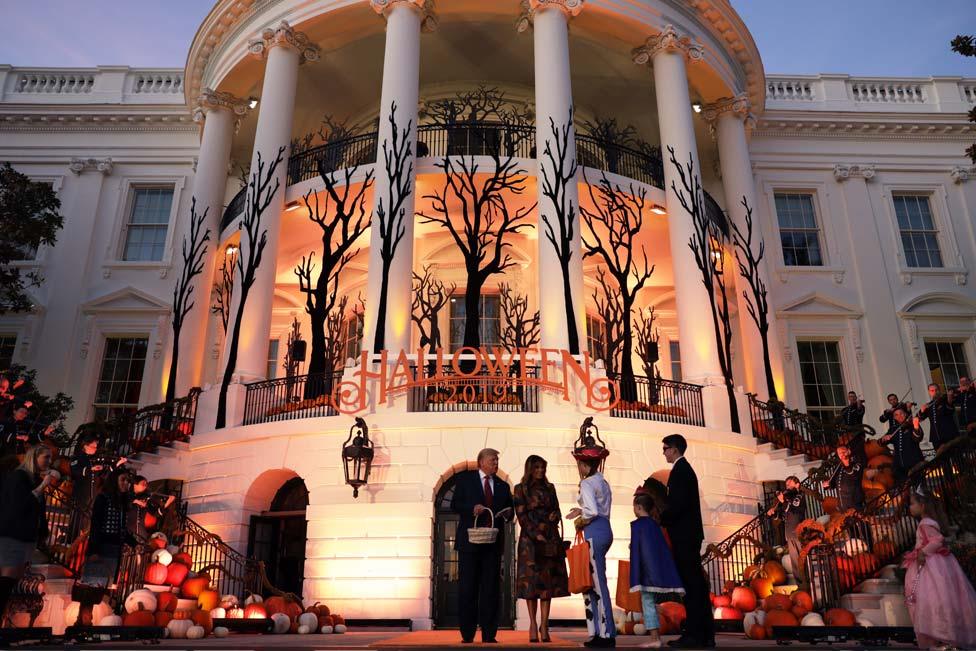 US President Donald Trump and First Lady Melania Trump handed out sweets in front of the White House