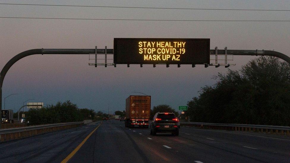 A freeway sign reads 'stay healthy, stop Covid-19, mask up AZ'