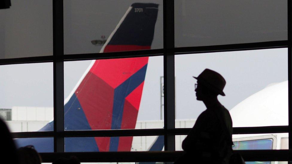 A passengers waits for a Delta Airlines flight in Terminal 5 at Los Angeles International Airport, May 4, 2017 in Los Angeles, California.