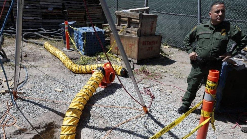 A border patrol special operations supervisor next to the entrance of a tunnel leading to Mexico from a lot along the border (20 April 2016)