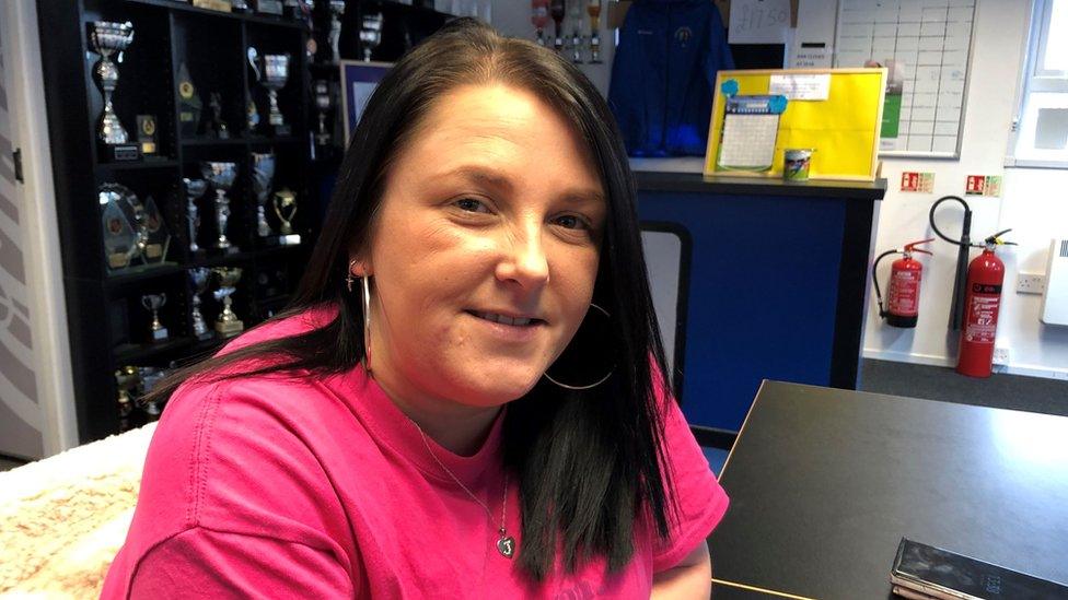 Carly Kingdon, Welfare Officer smiling in a pink top