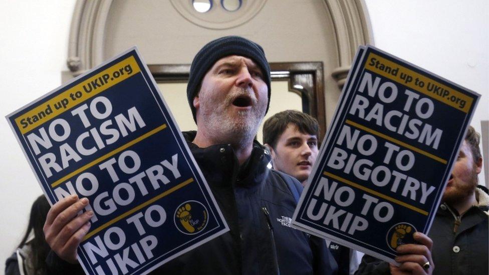 Protester holds posters