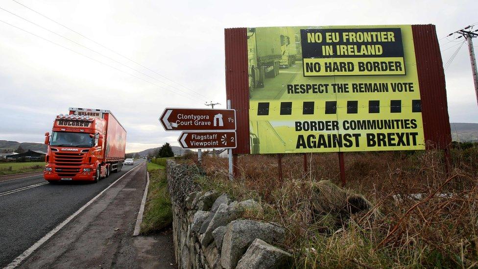 File image of traffic crossing the border into Northern Ireland from the Irish Republic past a Brexit Border poster on December 1, 2017