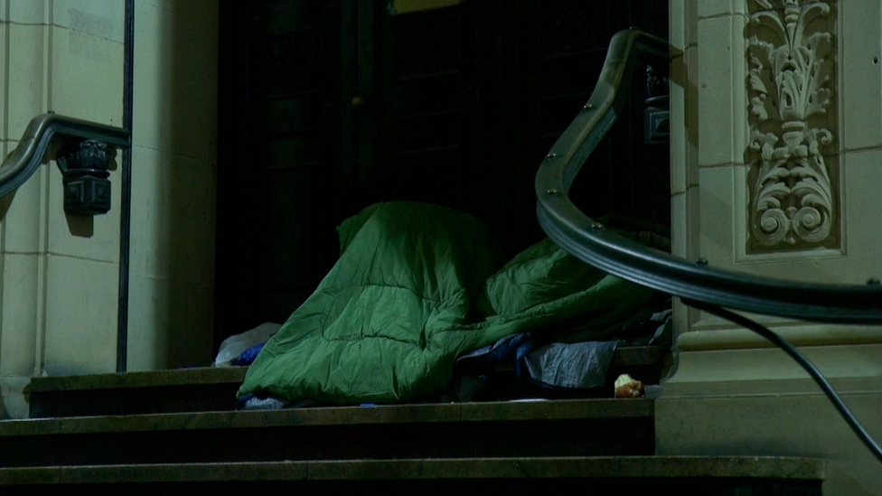 Man sleeping in doorway