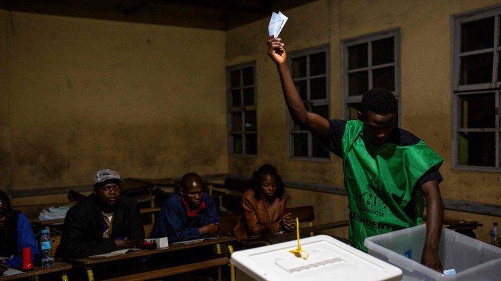 A National Electoral Commission (CNE) official counts votes at Chota Primary School in Beira on October 15, 2019, as part of the general election.