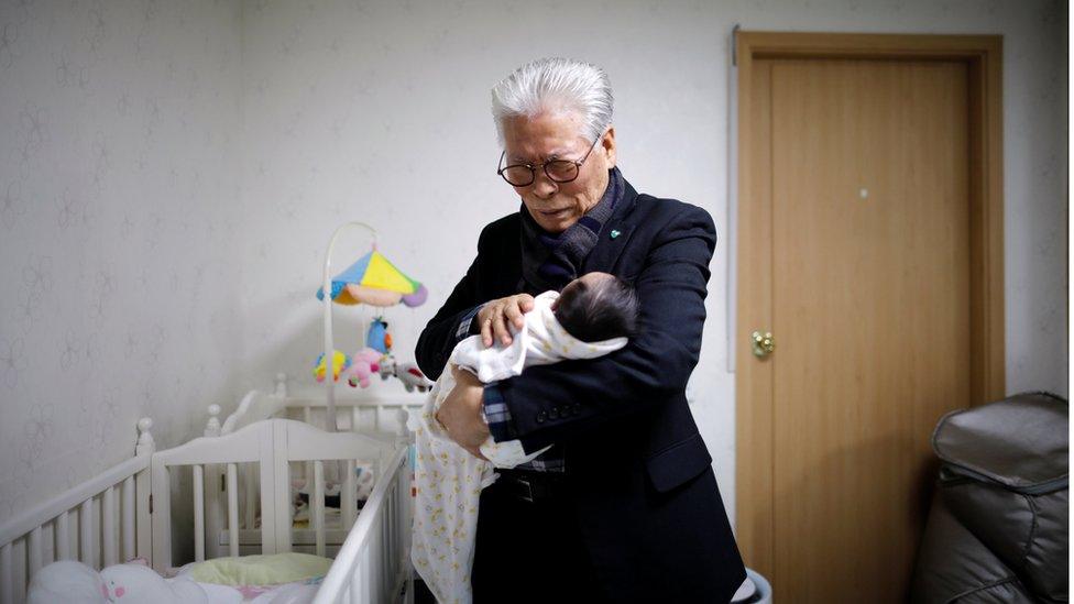 Lee Jong-rak, a senior pastor of Jusarang Community Church, prays for a baby who was left in the baby box in Seoul, 18 December 2018