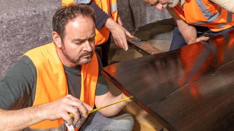 A table made from the wood of a 5,000-year-old oak tree enters Ely Cathedral