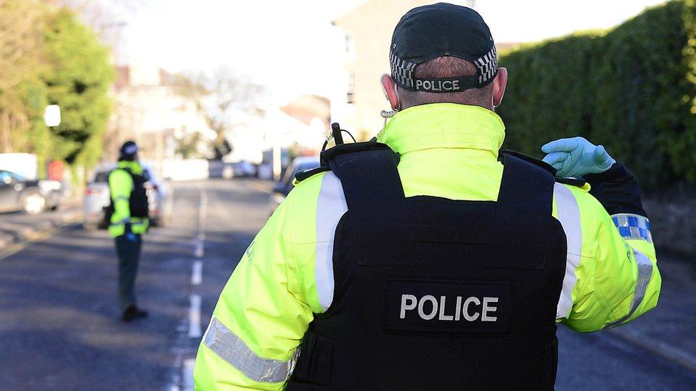 A police officer directs traffic