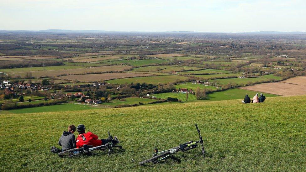 Members of the public enjoy some fresh air at Devil's Dyke, a National Trust beauty area, on March 21