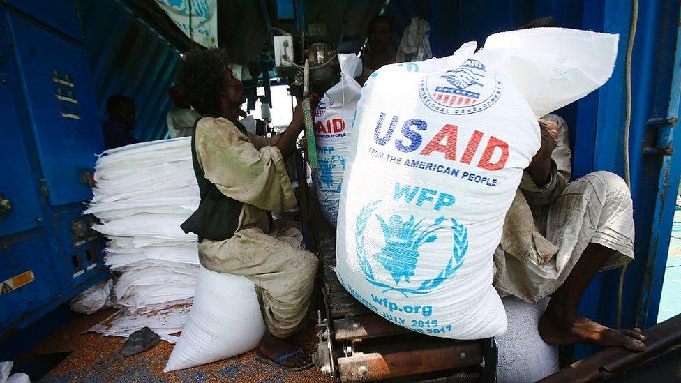 Sudanese dockers unload a US aid shipment organised by the US Agency for International Development and the World Food Programme at Port Sudan