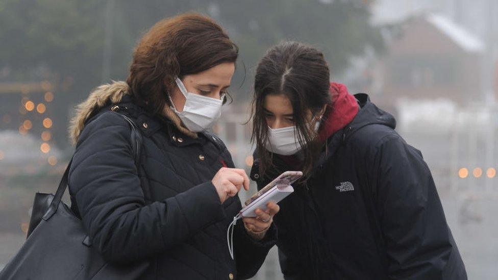 Women in Ukraine using a mobile phone