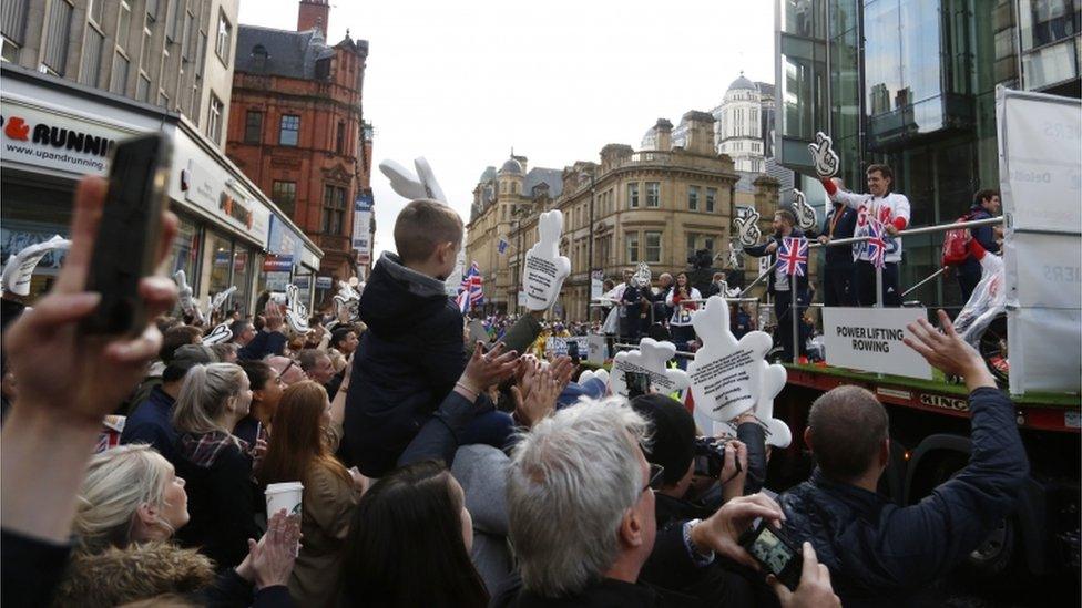 More than 150,000 people are braving the rain to line the parade route