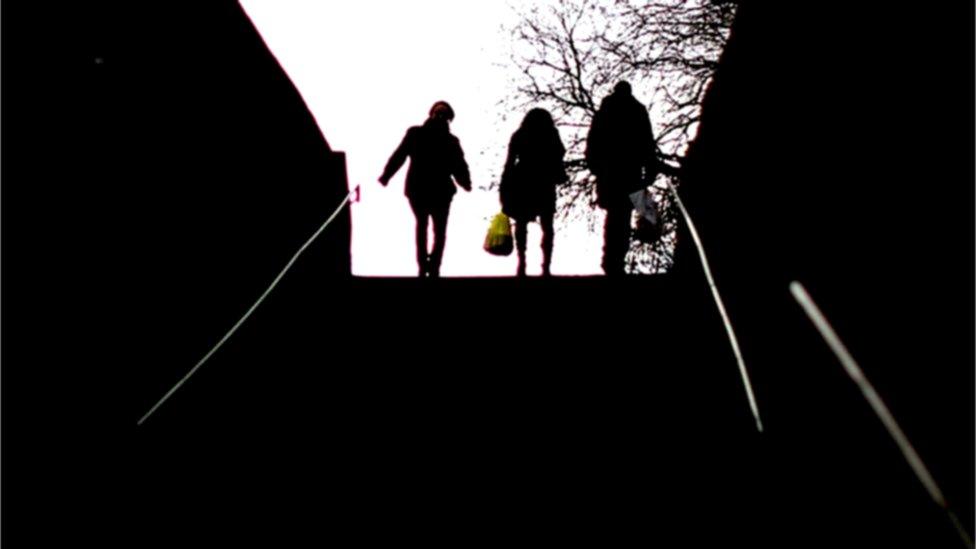 Three silhouetted figures - stock picture