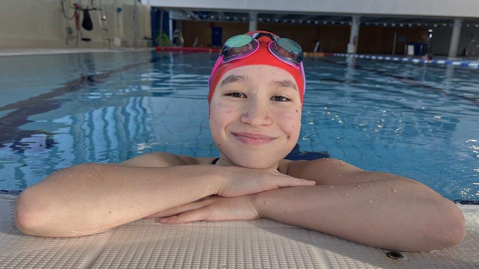 Andrea swimming and smiling