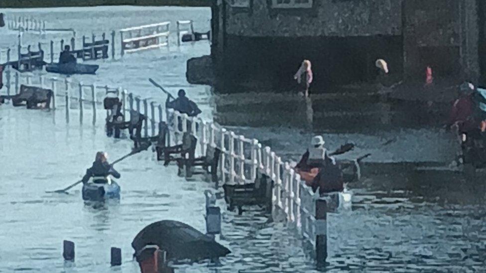 Blakeney in flood and people in kayaks