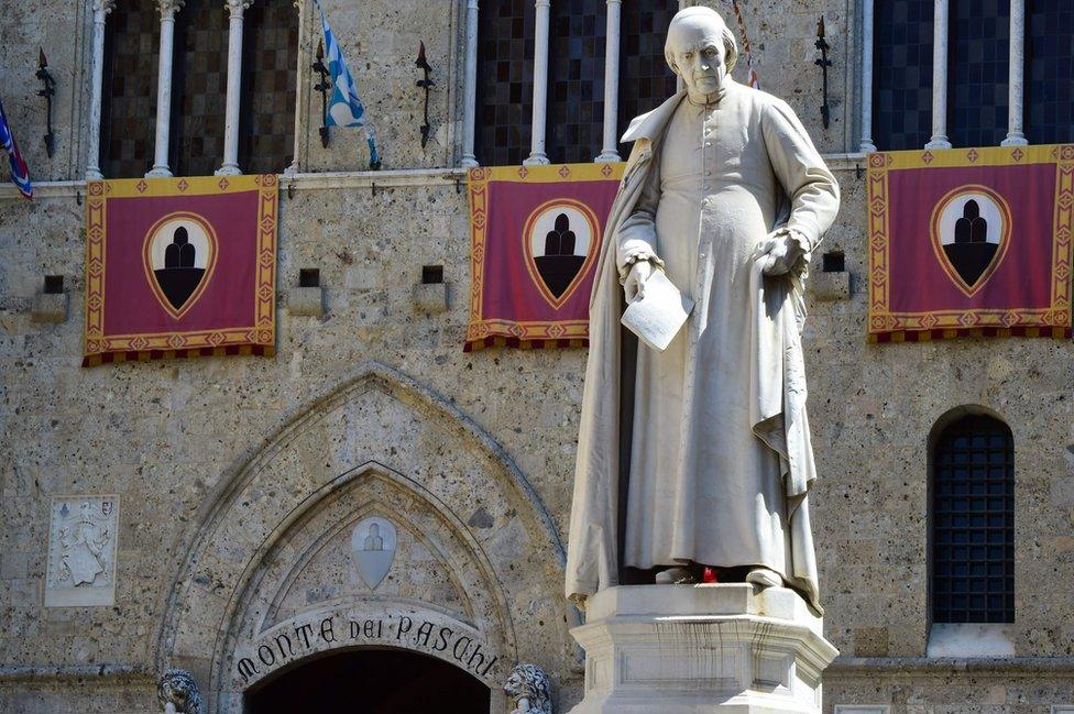 A statue of priest Sallustio Bandini at Piazza Salimbeni, the headquarters of the Monte dei Paschi di Siena bank in Siena, Tuscany.