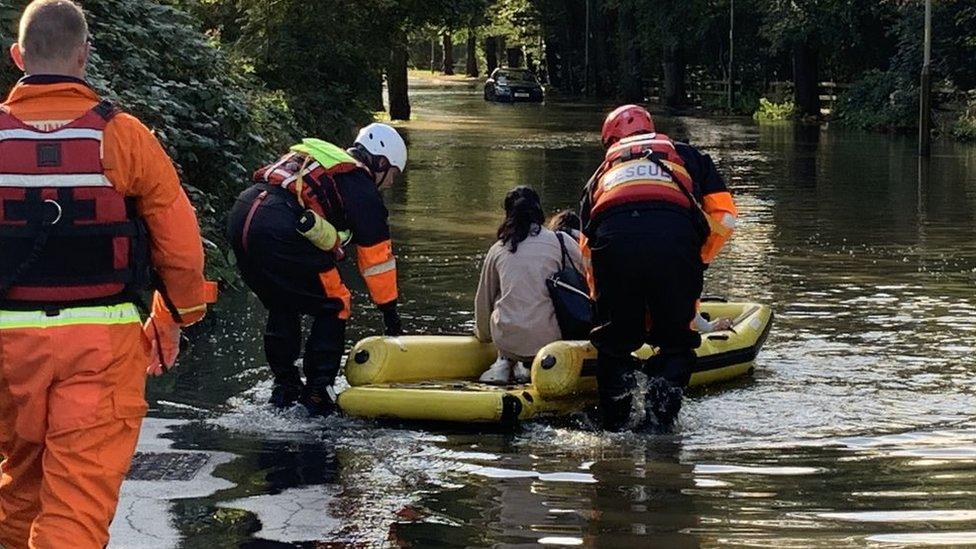 Family rescued by firefighters from flooded car